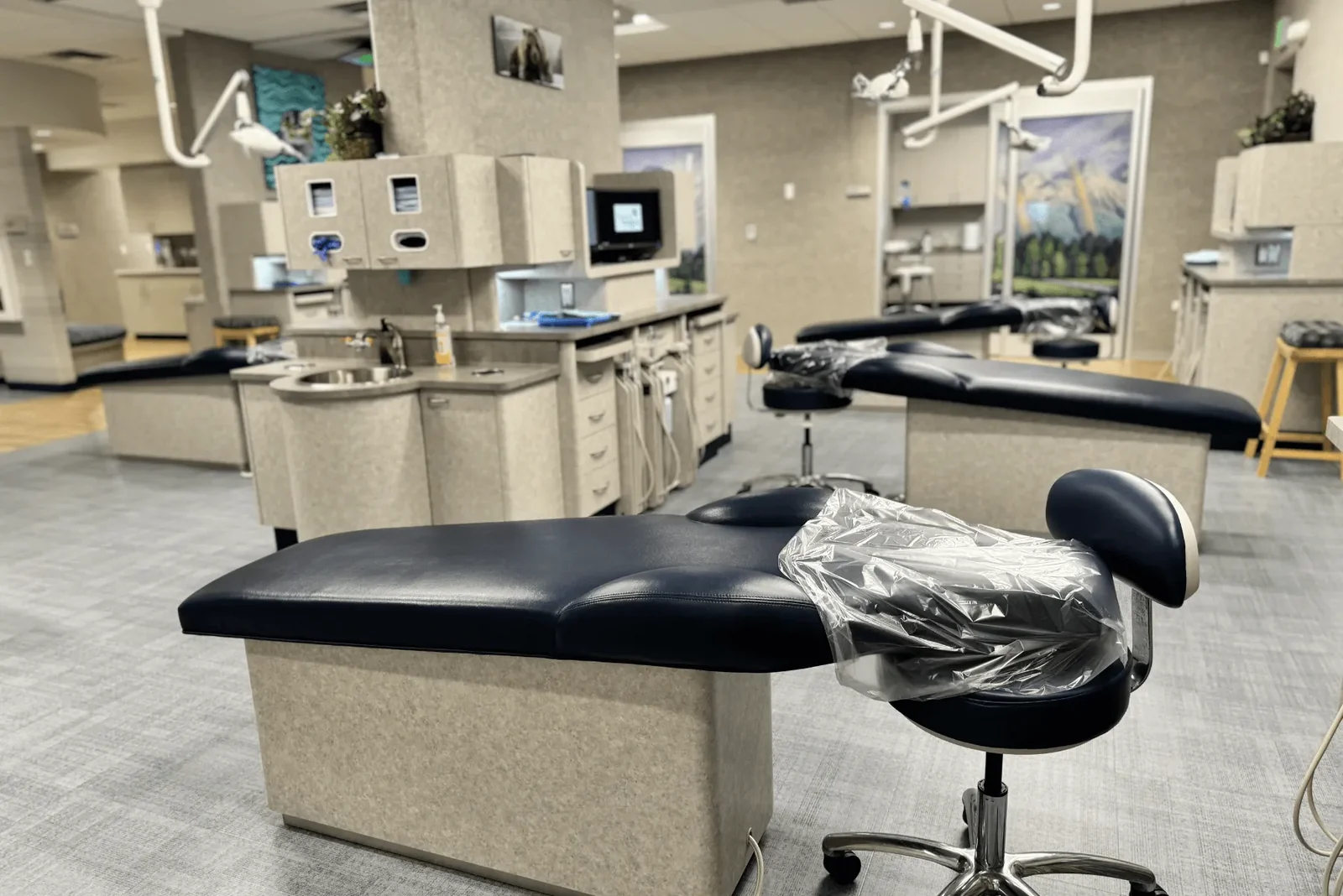 Open treatment room with dental chair and equipment.