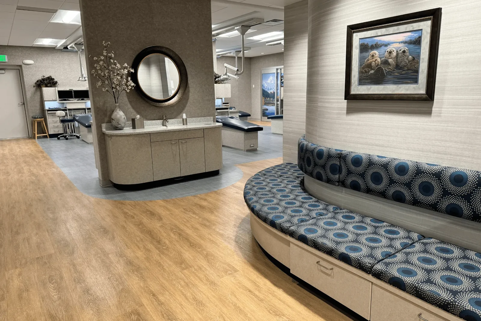 Office hallway with built-in seating and open treatment space nearby.