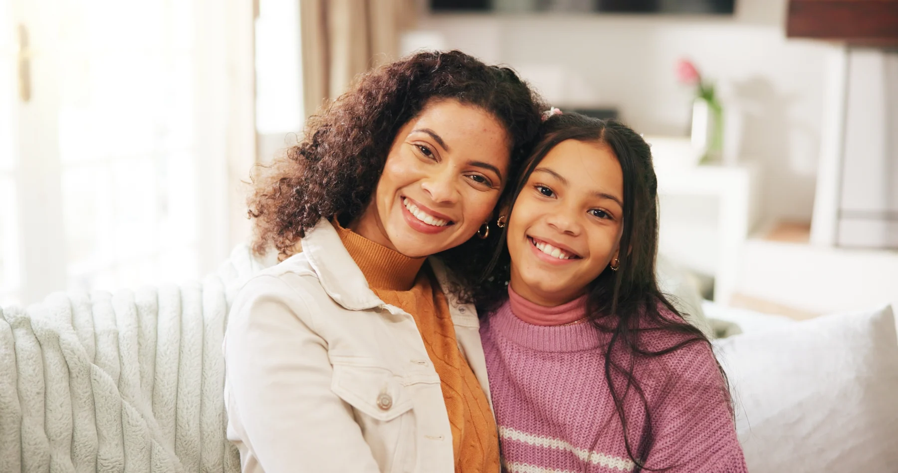 A smiling family together at home for Patient Information.